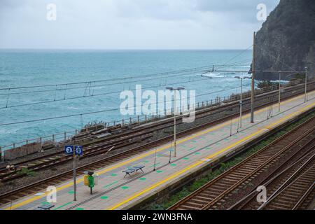 Overlook of the coastal railway track and platform with sea Stock Photo
