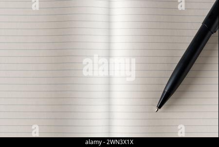 Top view of black ballpoint pen on lined note paper Stock Photo