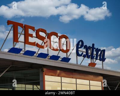 St Helens, UK - Jan 4 2024: Corporate signage at a Tesco Extra superstore in St Helens, Merseyside, England, UK. Stock Photo