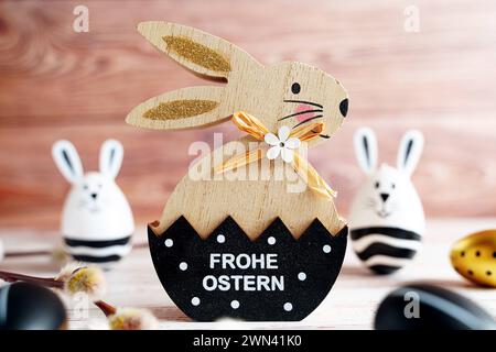 Augsburg, Bavaria, Germany - February 28, 2024: Happy Easter Greeting on an Easter bunny next to spring decoration *** Frohe Ostern Gruß auf einem Osterhase neben Frühlingsdekoration Stock Photo