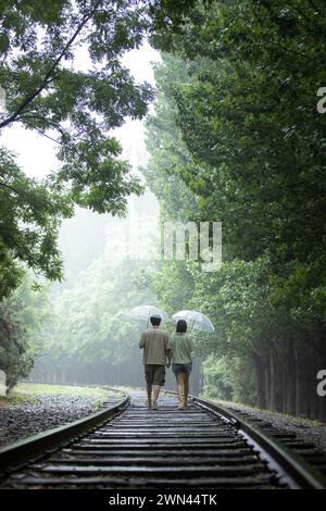 Young couple holding umbrellas Stock Photo