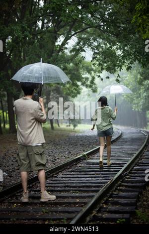 Young couple holding umbrellas Stock Photo