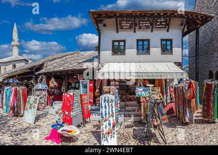 MOSTAR, BOSNIA AND HERZEGOVINA - AUGUST 15, 2022: Small souvenir shops located on the picturesque historical streets in the center of the city. Old br Stock Photo