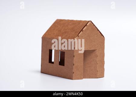simple DIY family home - cardboard model on white background Stock Photo
