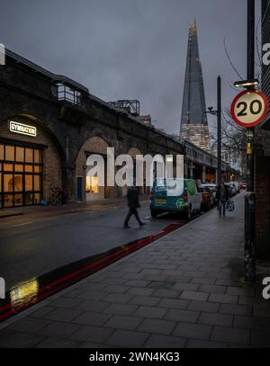 Southwark, London, UK: Druid Street alongside the London Bridge to Greenwich Railway Viaduct with view of the Shard skyscraper Stock Photo