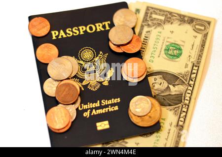 American dollars, coins on the United States of American passport, passports are issued to the American citizens and nationals, Travel, tourism concep Stock Photo
