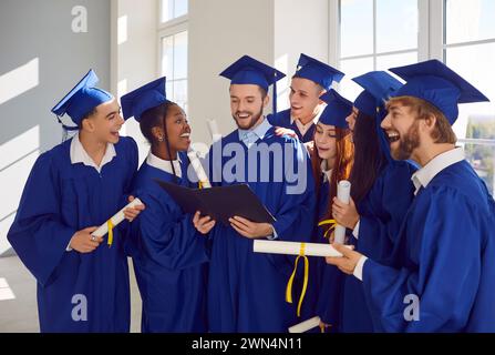 Group portrait of young happy diverse graduate students, celebrating together degree completion Stock Photo