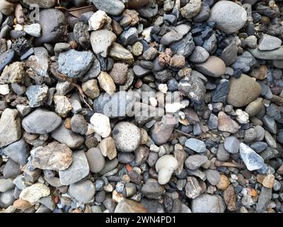 Beautiful gravel surface wet from rain. Gravel background for design. Gravel stone texture. Small stone background Stock Photo