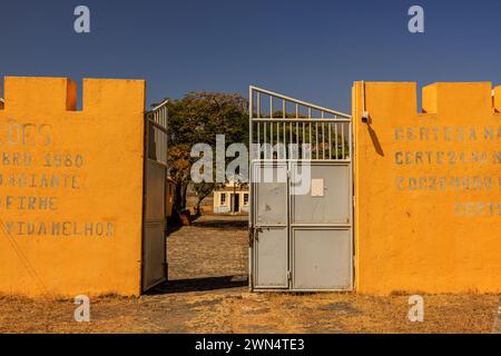 yellow walls and open entrance gate of the Portuguese Tarrafal Concentration camp on Santiago island Cabo Verde Stock Photo