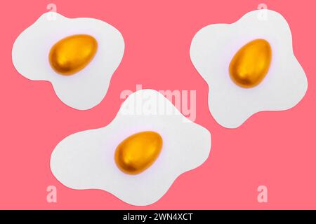 Creative layout made of scrambled eggs with decorated golden Easter eggs on a pink background. Minimal pink pattern background. Spring holidays concep Stock Photo