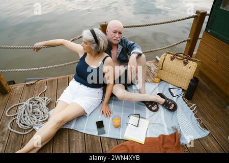High angle view of senior couple sitting together on houseboat Stock Photo