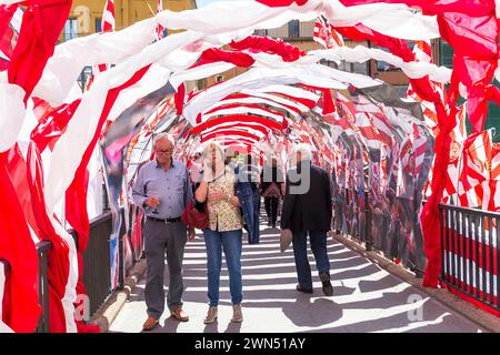 GIRONA, SPAIN - MAY 14, 2017: These are unidentified people on the St. Augoustin Bridge, decorated for the Festival of Flowers. Stock Photo
