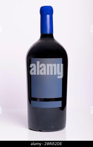 An imperial Bordeaux bottle contains red wine on a white background Stock Photo
