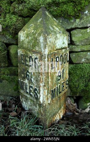 Mile post for distances to Leeds and Liverpool on the Leeds-Liverpool canal near Bank Newton, Gargrave, North Yorkshire. Stock Photo