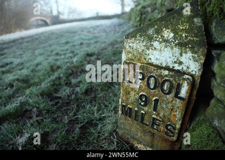 Mile post for 91 miles to Liverpool on the Leeds-Liverpool canal near Bank Newton, Gargrave, North Yorkshire. Stock Photo