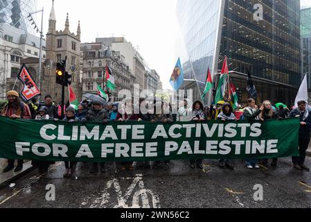 London, UK. 29 February, 2024. Activists from a coalition including Extinction Rebellion, StopEACOP, War on Want, and Global Justice Now rally at Lloyd's of London before staging a 'Climate Activists for a Free Palestine' march to Axa Insurance on the fourth day of a global week of 'Insure Our Future' events hoping to pressure the industry into doing more to combat the climate emergency. The insurance giant Axa, activists say, both insures fossil fuel projects and finances Israel's project of building illegal settlements on Palestinian land. Credit: Ron Fassbender/Alamy Live News Stock Photo