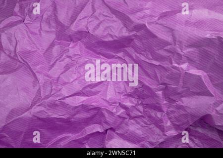 Сrumpled paper texture purple. Texture of crumpled paper. Crumpled paper. Wrinkles paper. Stock Photo
