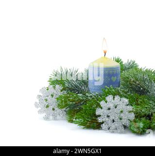 Fir branch with Christmas tinsel and candle .Fir branch with Christmas tinsel and  candle. Christmas and New Year festive background. Isolated on whit Stock Photo