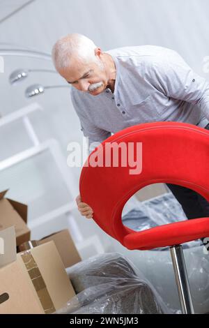 senior man assembling chair before moving Stock Photo