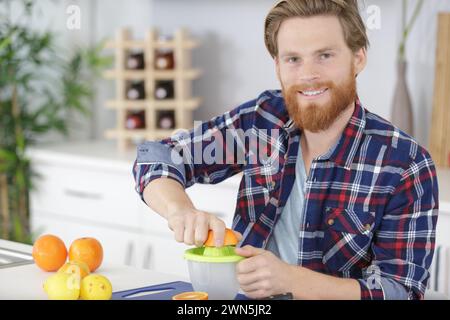 old man squeezing an orange Stock Photo