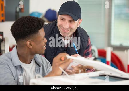 supervisor and apprentice in friendly communication Stock Photo