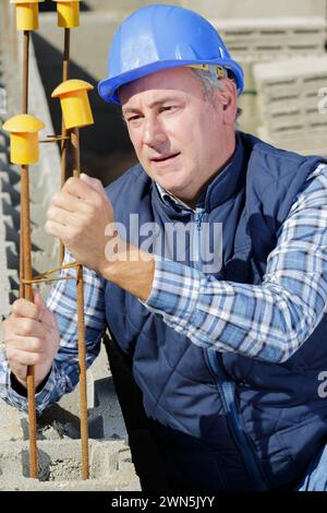 closeup shot of concrete casting on reinforcing metal bars Stock Photo