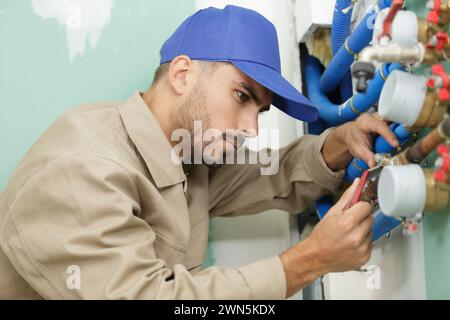 plumber technician works with water meter Stock Photo