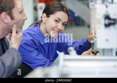 happy female worker in a metal workshop Stock Photo