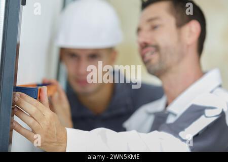 male hands making window measurements Stock Photo