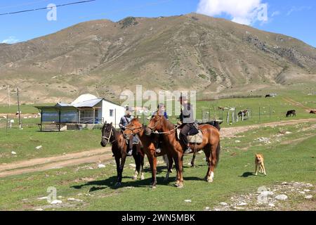 August 31 2023 - Semyonovka, Kyrchyn Valley in Kyrgyzstan: People riding horses in north of Kyrgyzstan mountains Stock Photo