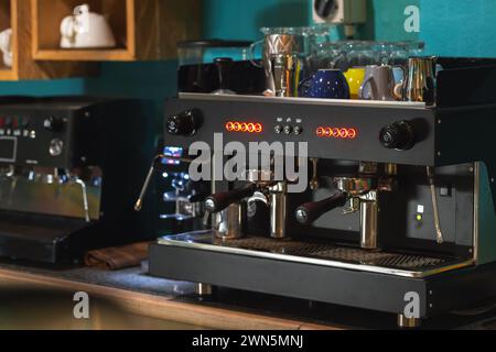 Professional black coffee machine stands on a desk in a cafeteria Stock Photo
