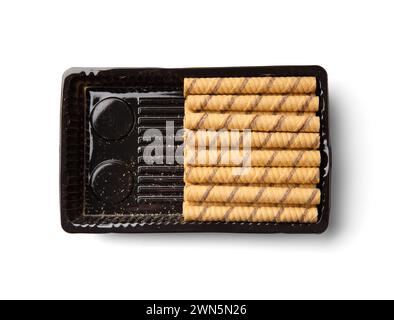 Chocolate crunchy wafer rolls with cream filling in a package isolated on a white background. Half a pack of waffles Stock Photo