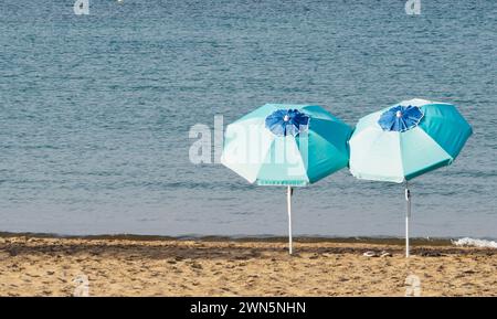 Two umbrellas on the beach Stock Photo