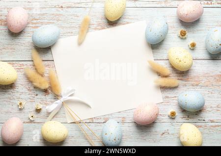 Easter greeting card with Easter eggs and spikelets on light wooden background with copy space. Stock Photo