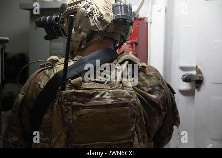 A U.S. Army Green Beret from 10th Special Operations Group (Airborne) clears a room during Close Quarters Combat training with U.S. East Coast-based Naval Special Warfare Operators (SEALs), and Norwegian Special Operations Commandos during Arctic Edge 24 (AE24) in Kodiak, Alaska, Feb. 24, 2024. AE24 is an annual defense exercise for the U.S. Northern Command emphasizing Joint Force operations in an extreme cold weather and high latitude environment and is designed to demonstrate Globally Integrated Layered Defense in the Arctic. (U.S. Army photo by Spc. Preston Mothersole) Stock Photo