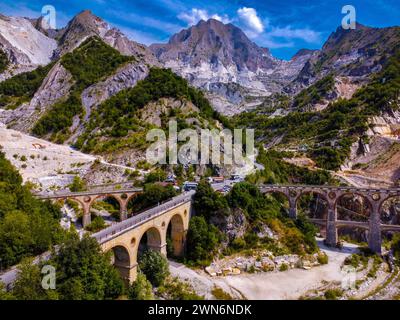 Apuan Alps, white marble quarries, Fantiscritti valley, the Vara bridges structures, marble railway in the past, marble blocks transport trucks road Stock Photo