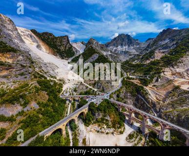 Apuan Alps, white marble quarries, Fantiscritti valley, the Vara bridges structures, marble railway in the past, marble blocks transport trucks road Stock Photo