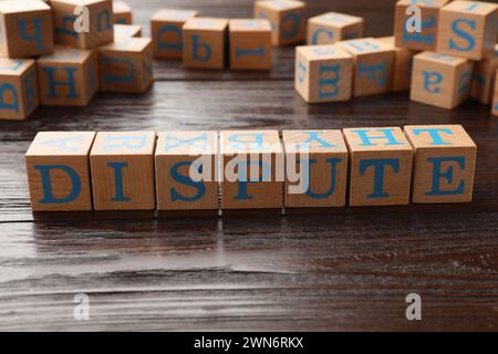 Cubes with word Dispute on dark wooden table Stock Photo
