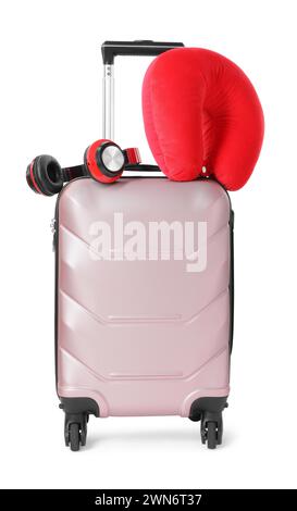 Red travel pillow and headphones on suitcase against white background Stock Photo