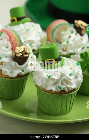 St. Patrick's day party. Tasty festively decorated cupcakes on table, closeup Stock Photo