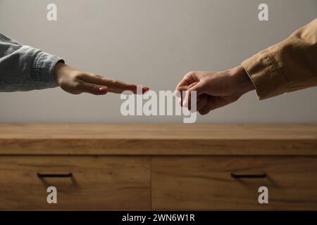People playing rock, paper and scissors indoors, closeup Stock Photo