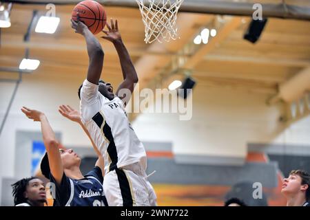Illinois, USA. Elevated forward slamming home two points above a watching defender. Stock Photo