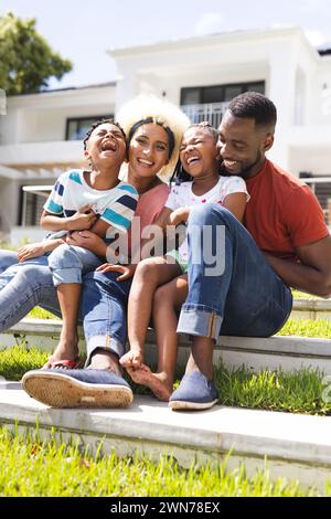 African American family enjoys a sunny day outdoors, laughter fills the air Stock Photo