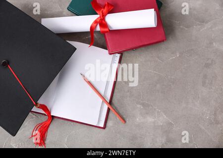 Mortar board with diploma and notebooks on beige background Stock Photo ...