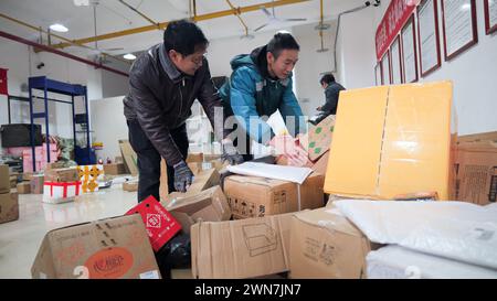 ENSHI, CHINA - MARCH 1, 2024 - Staff members are sorting express deliveries at the investment department of Hanghang Road in Enshi, Central China's Hu Stock Photo