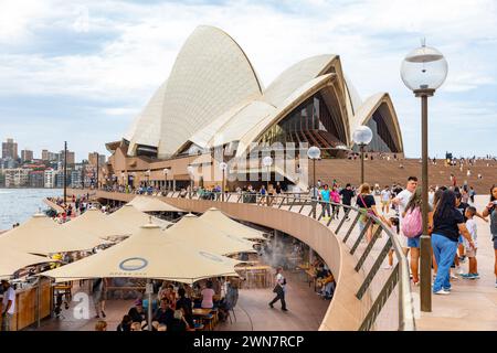 Sydney Opera House building, 2024, at bennelong point in Sydney with people enjoying lunch at Sydney opera house bar and restaurant, iconic Stock Photo