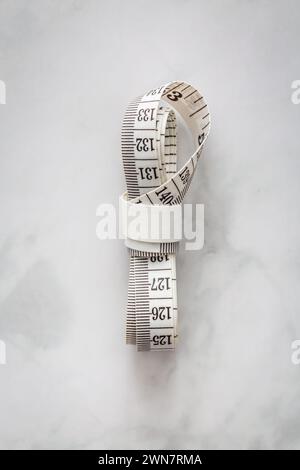 Tape measure on marble table Stock Photo