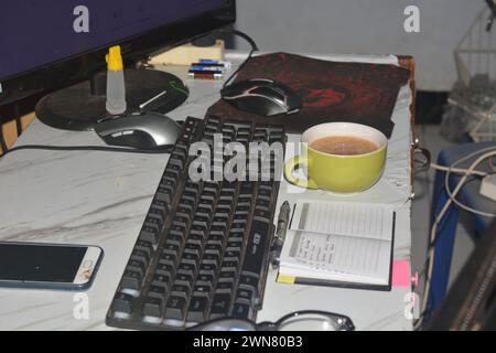 28 September 2023, Photo of work desk with laptop, computer, cup of coffee.Indonesia Stock Photo