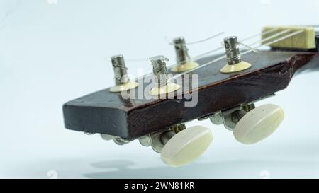 Ukulele head with 4 tuners and strings Stock Photo