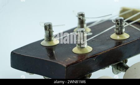 Ukulele head with 4 tuners and strings Stock Photo
